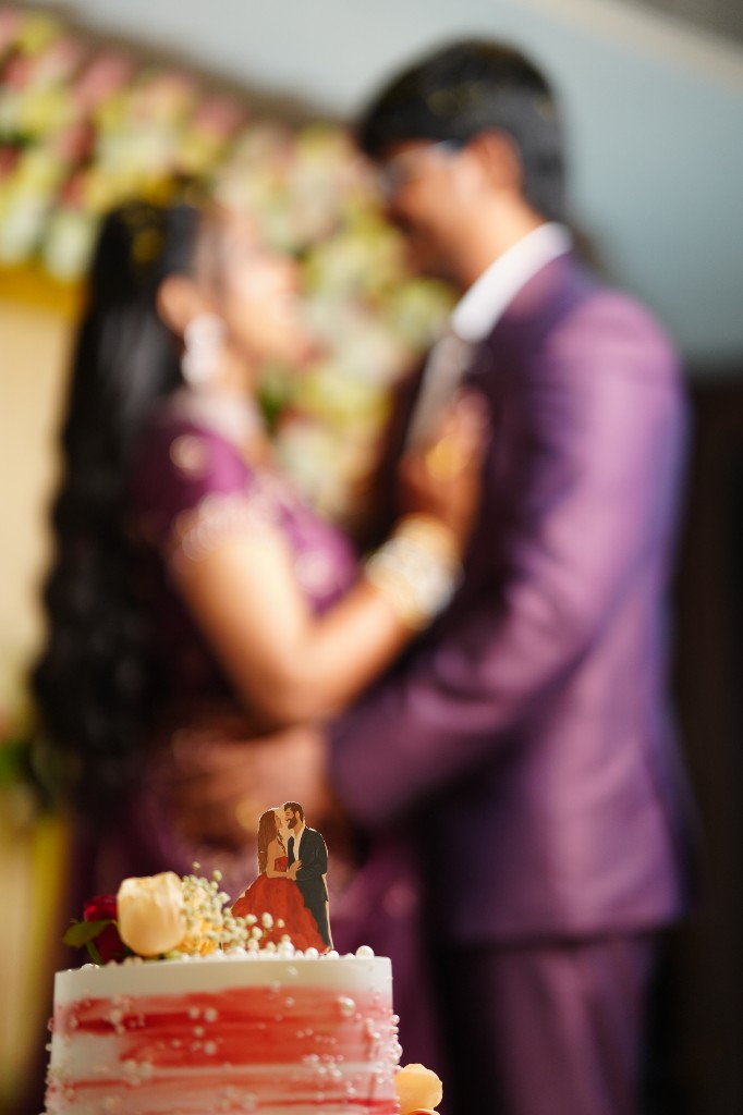 Couple with wedding cake at the reception
